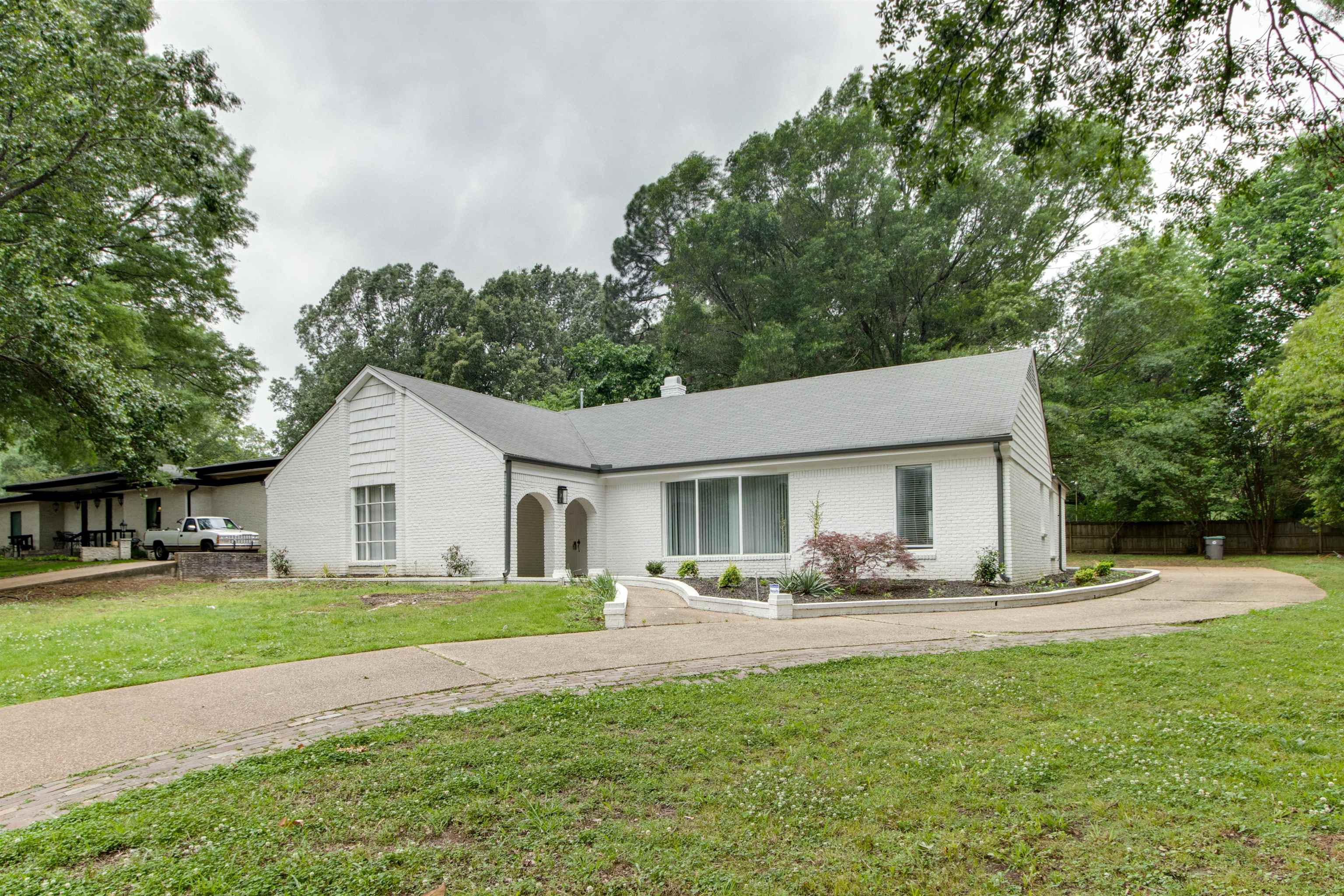 a front view of house with yard and green space