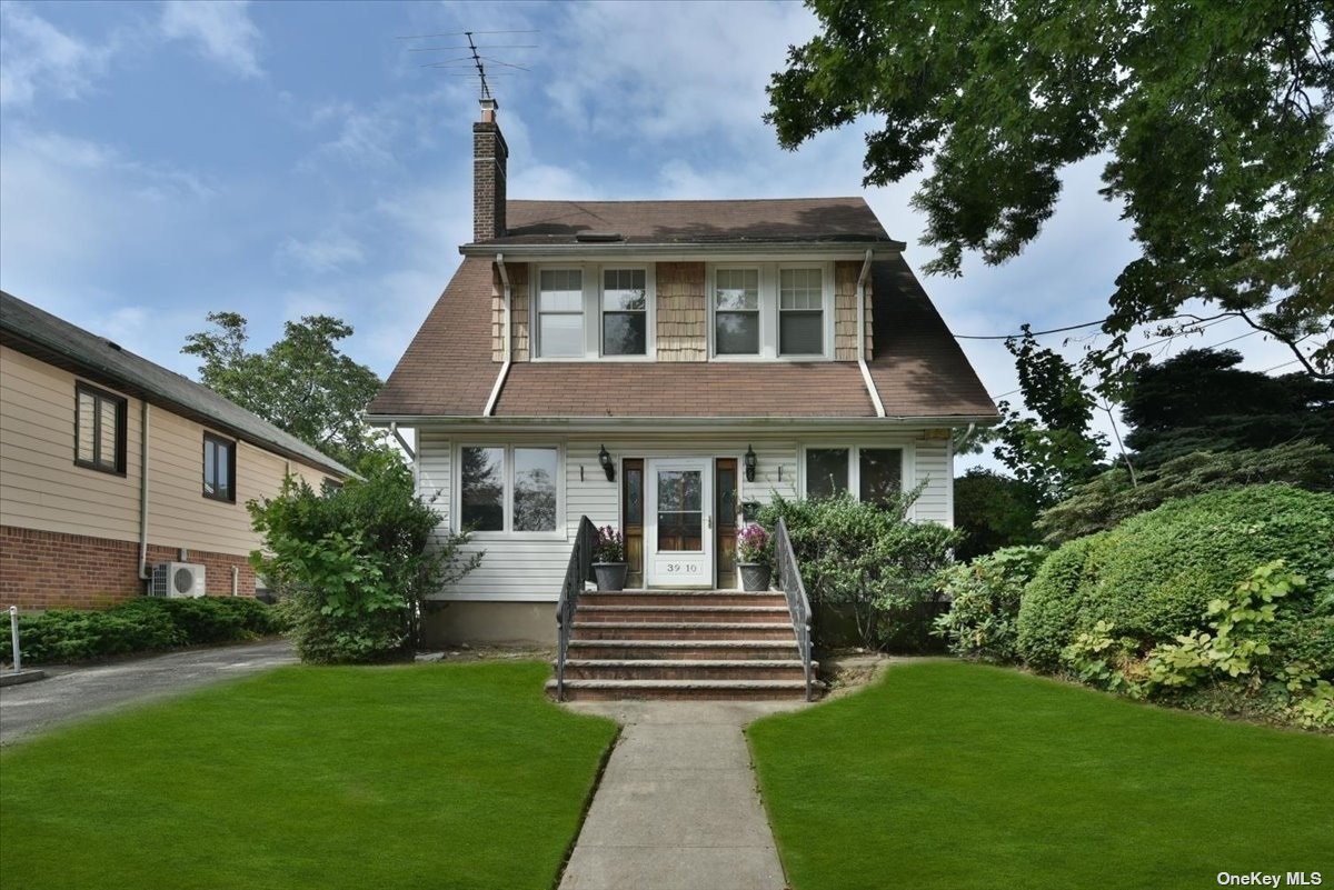 a front view of a house with a garden