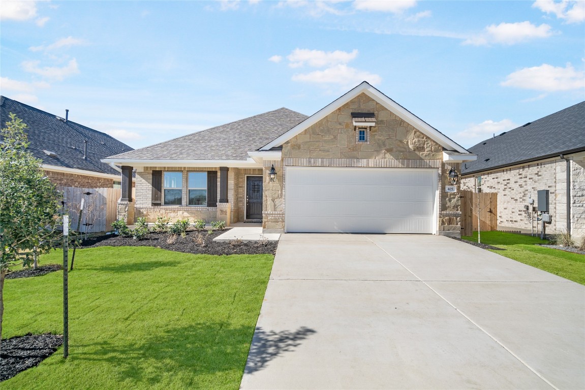 a front view of house with yard and green space