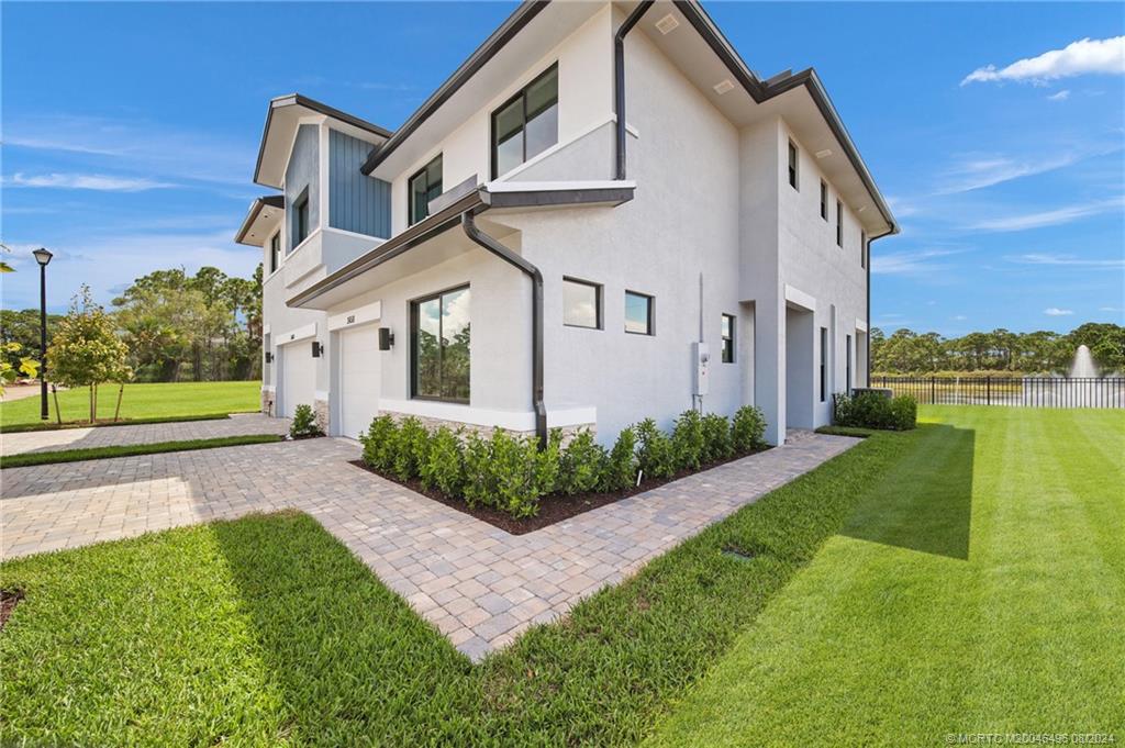 a front view of a house with a yard