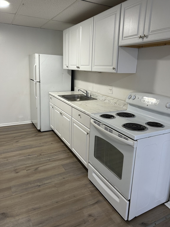 a kitchen with granite countertop wooden cabinets stainless steel appliances and a sink