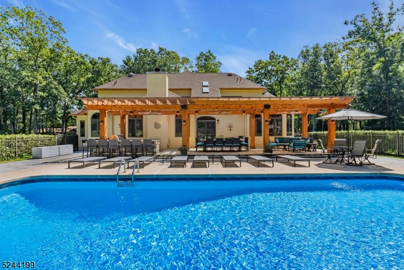 a view of a house with swimming pool and sitting area