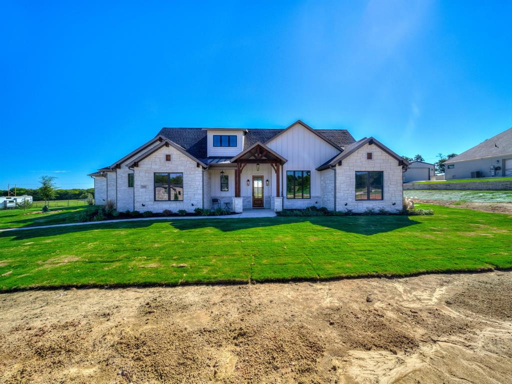 a house with green field in front of it