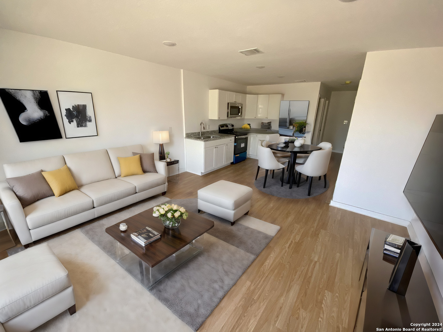 a living room with furniture couches and a flat screen tv