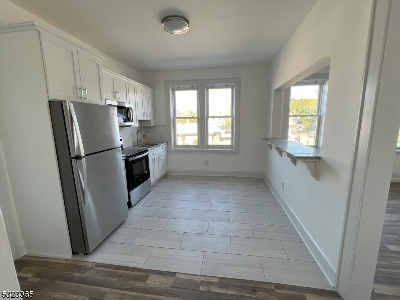 a view of a kitchen with a refrigerator a sink dishwasher and a refrigerator