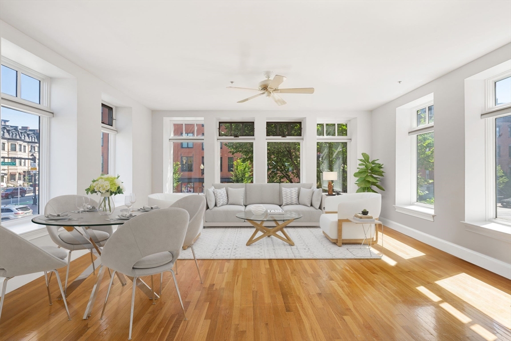 a living room with furniture and large windows