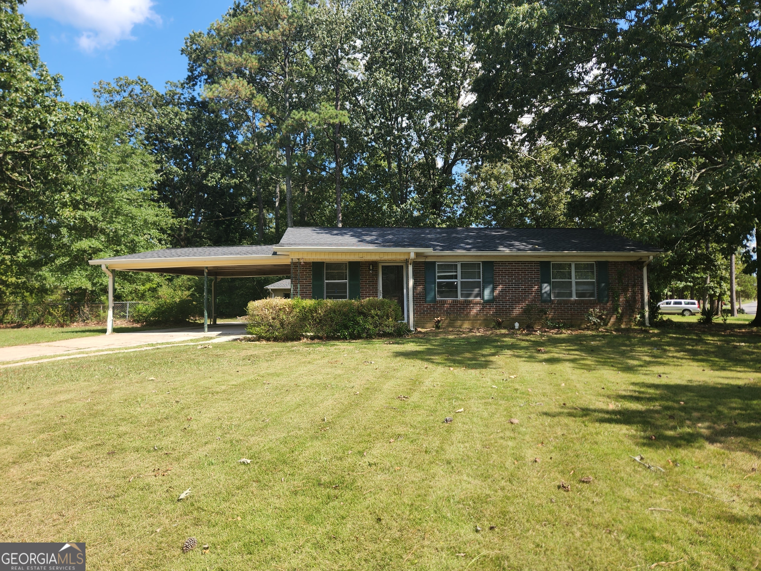 a view of a house with swimming pool and a yard