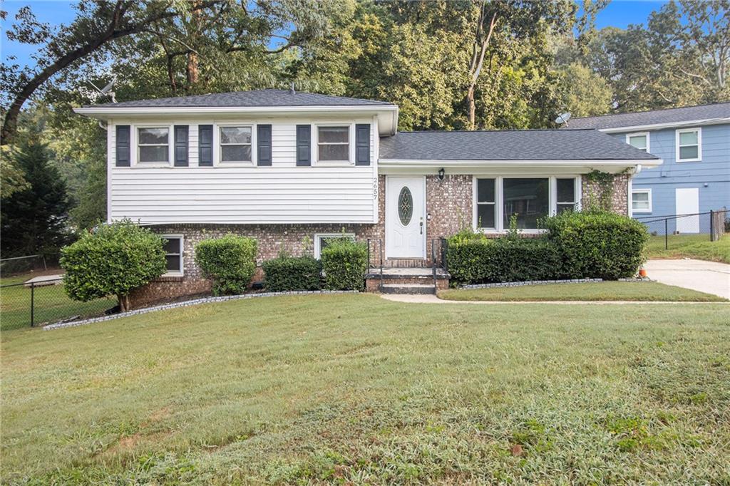 a front view of house with yard and green space