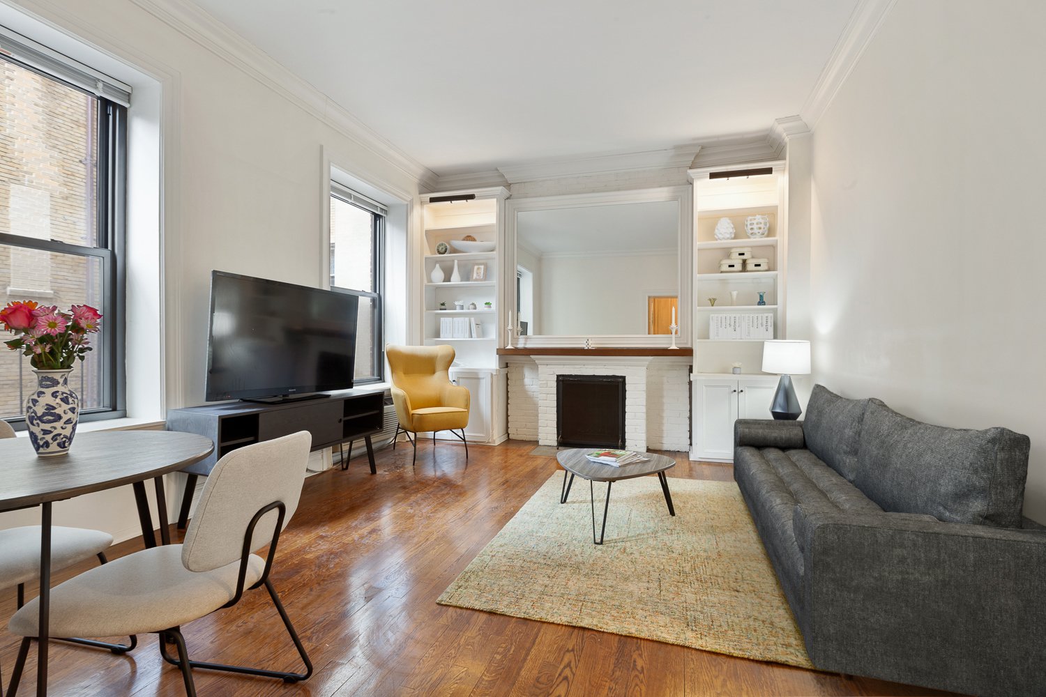 a living room with furniture a fireplace and a flat screen tv