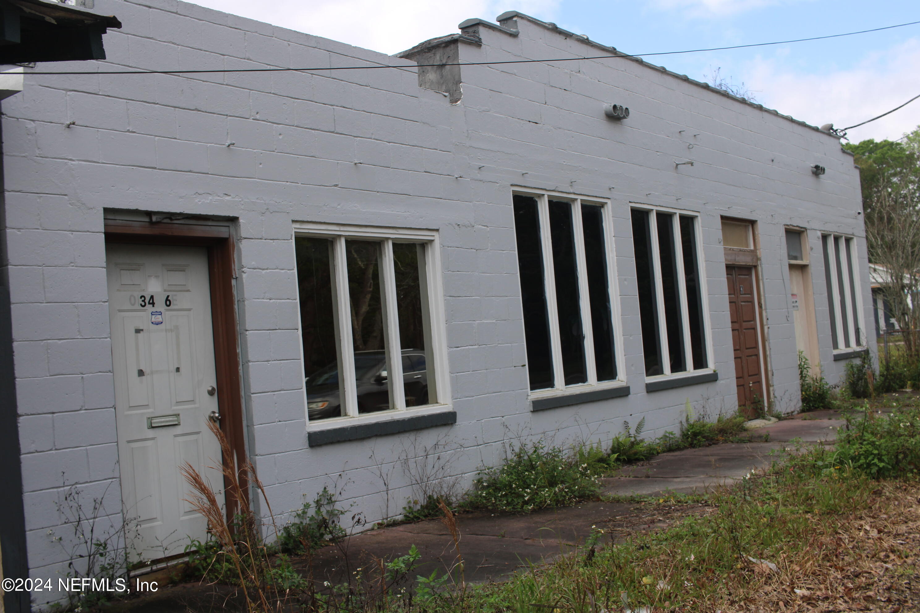 a front view of a house with plants