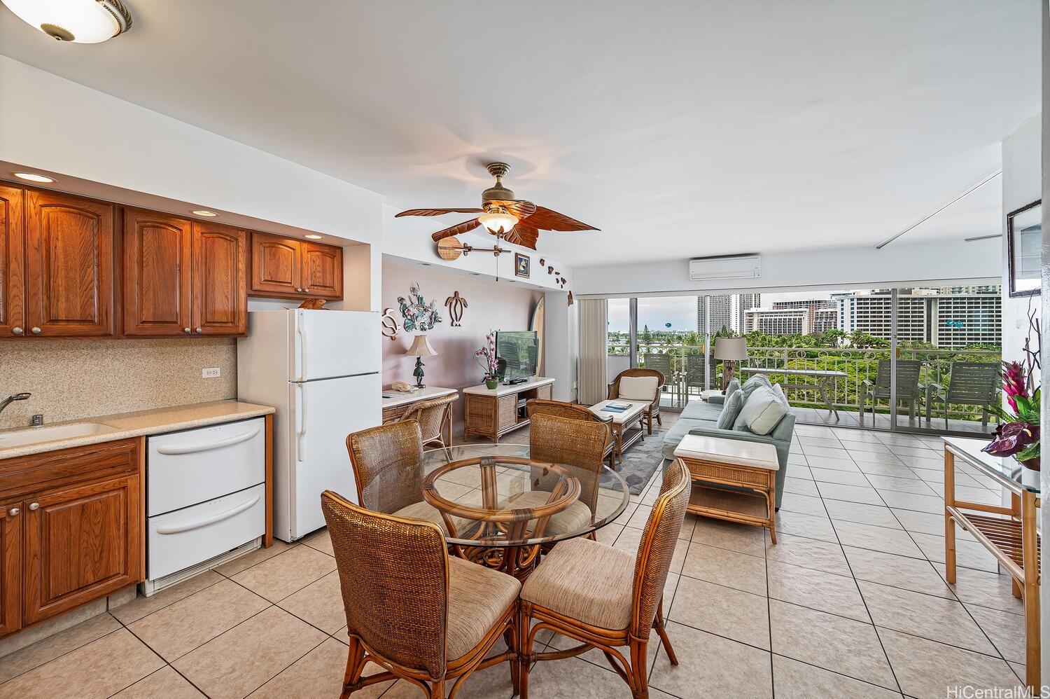 a living room with furniture a rug and a kitchen view