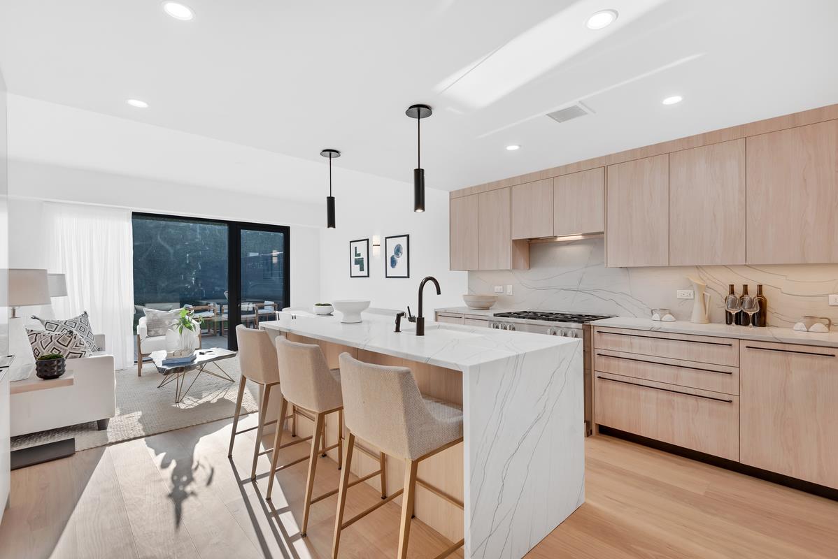 a kitchen with a sink cabinets and window