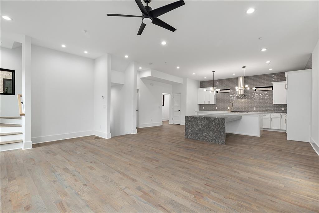 a view of kitchen with kitchen island a sink stainless steel appliances and cabinets