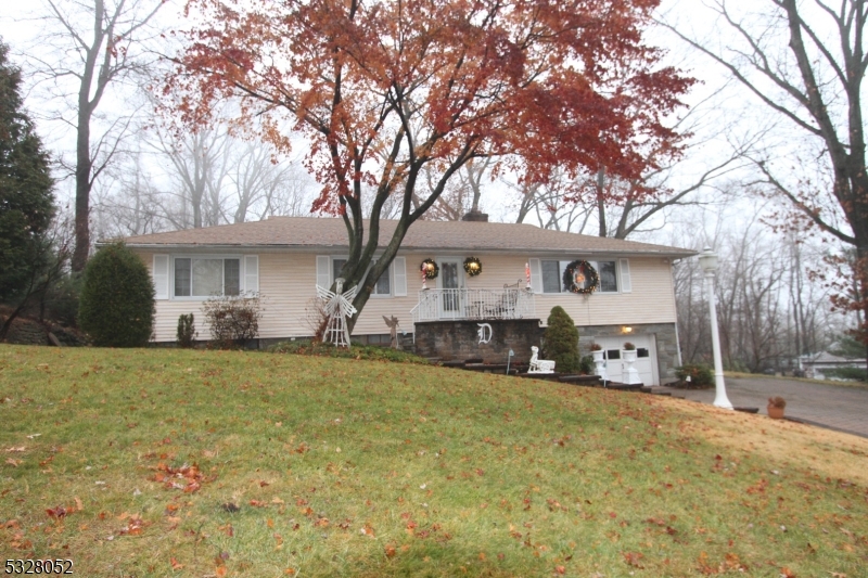 a view of a house with a yard covered in snow