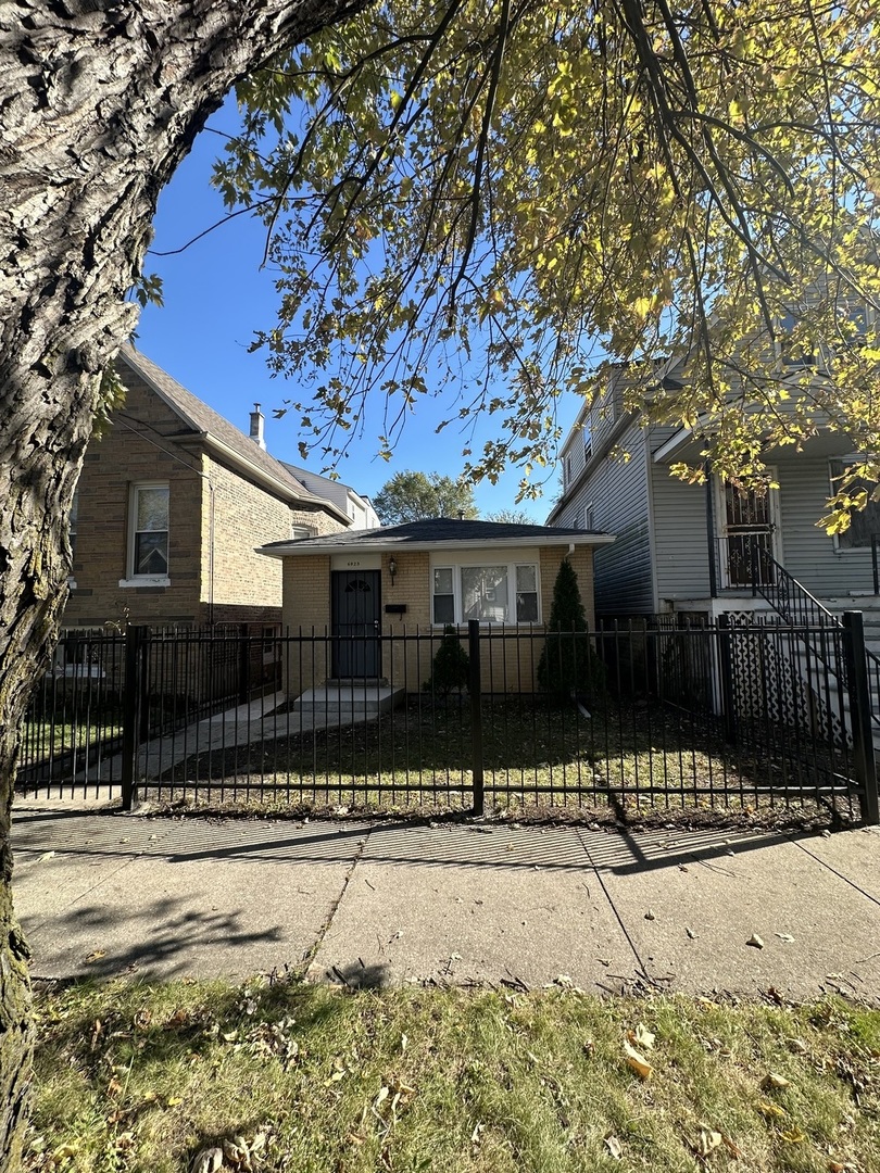 a front view of a house with a yard covered with snow