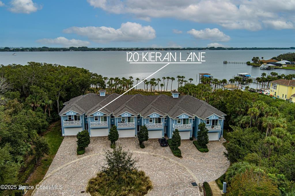 an aerial view of a house with garden space and lake view