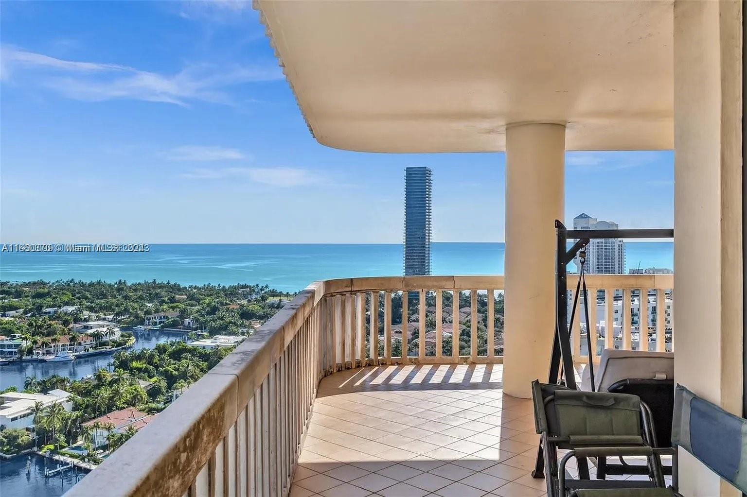 a view of a balcony with chair and city view