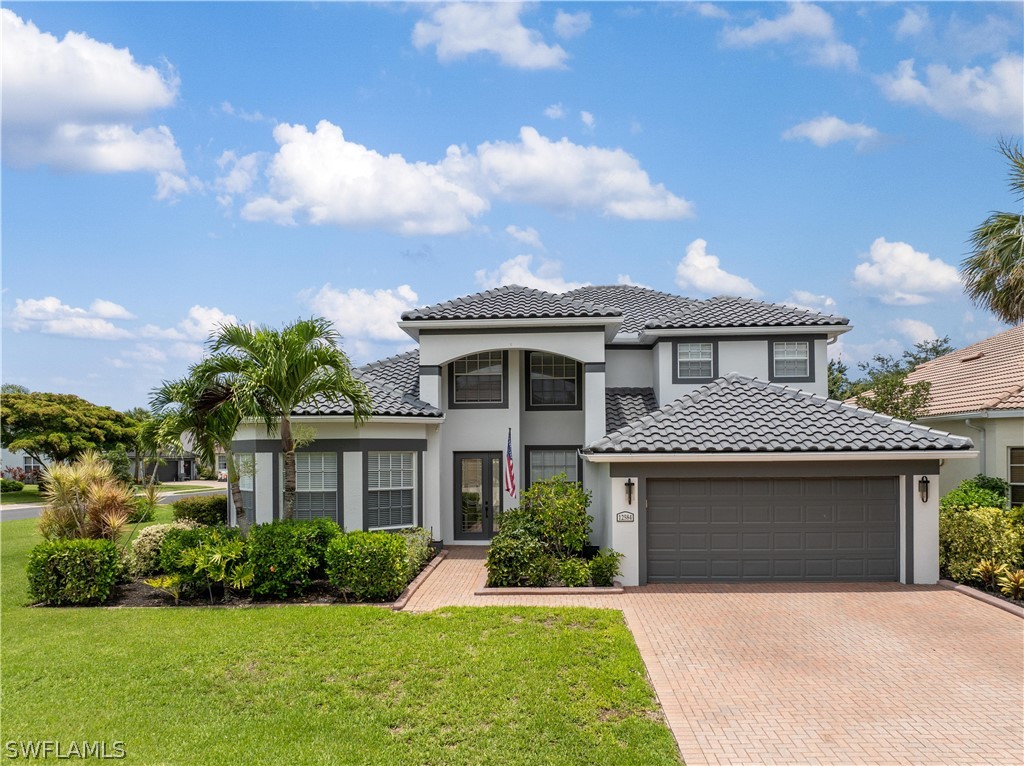 a front view of a house with a yard and garage