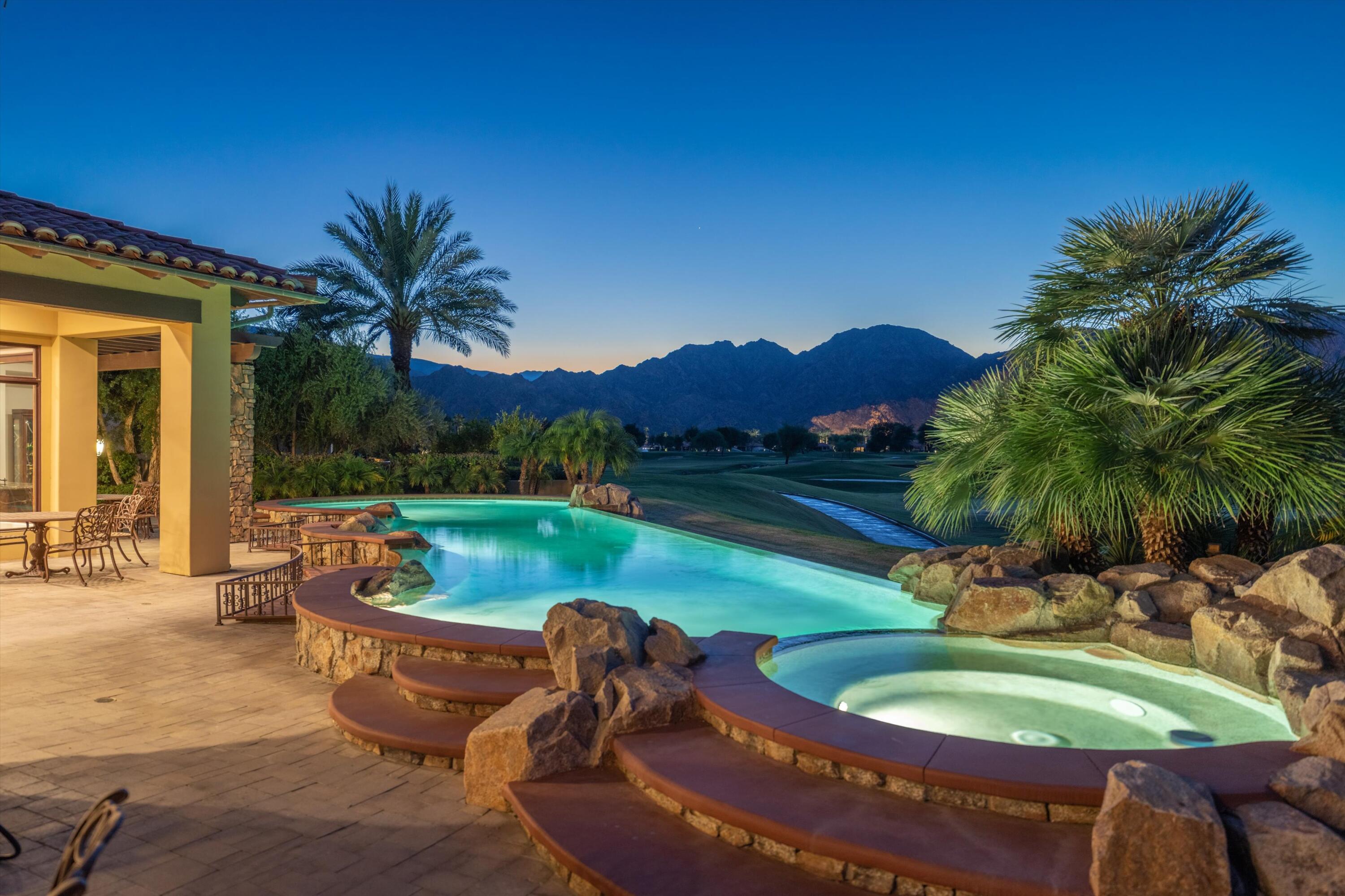 a view of a swimming pool with a patio and a yard