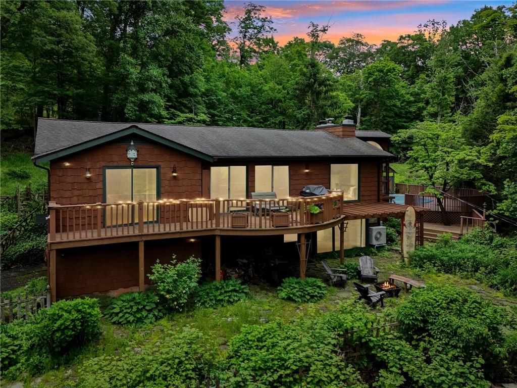 Back house at dusk with a wooden deck