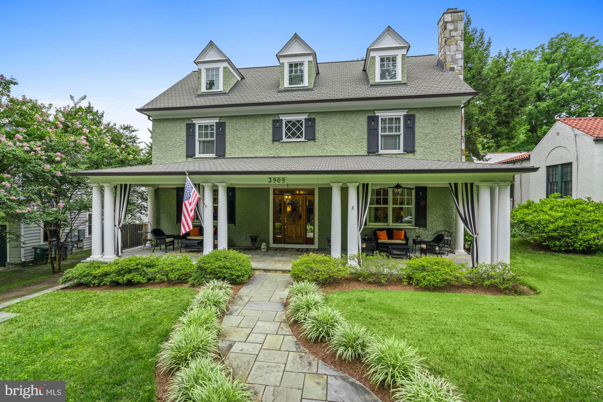 front view of a brick house with a yard