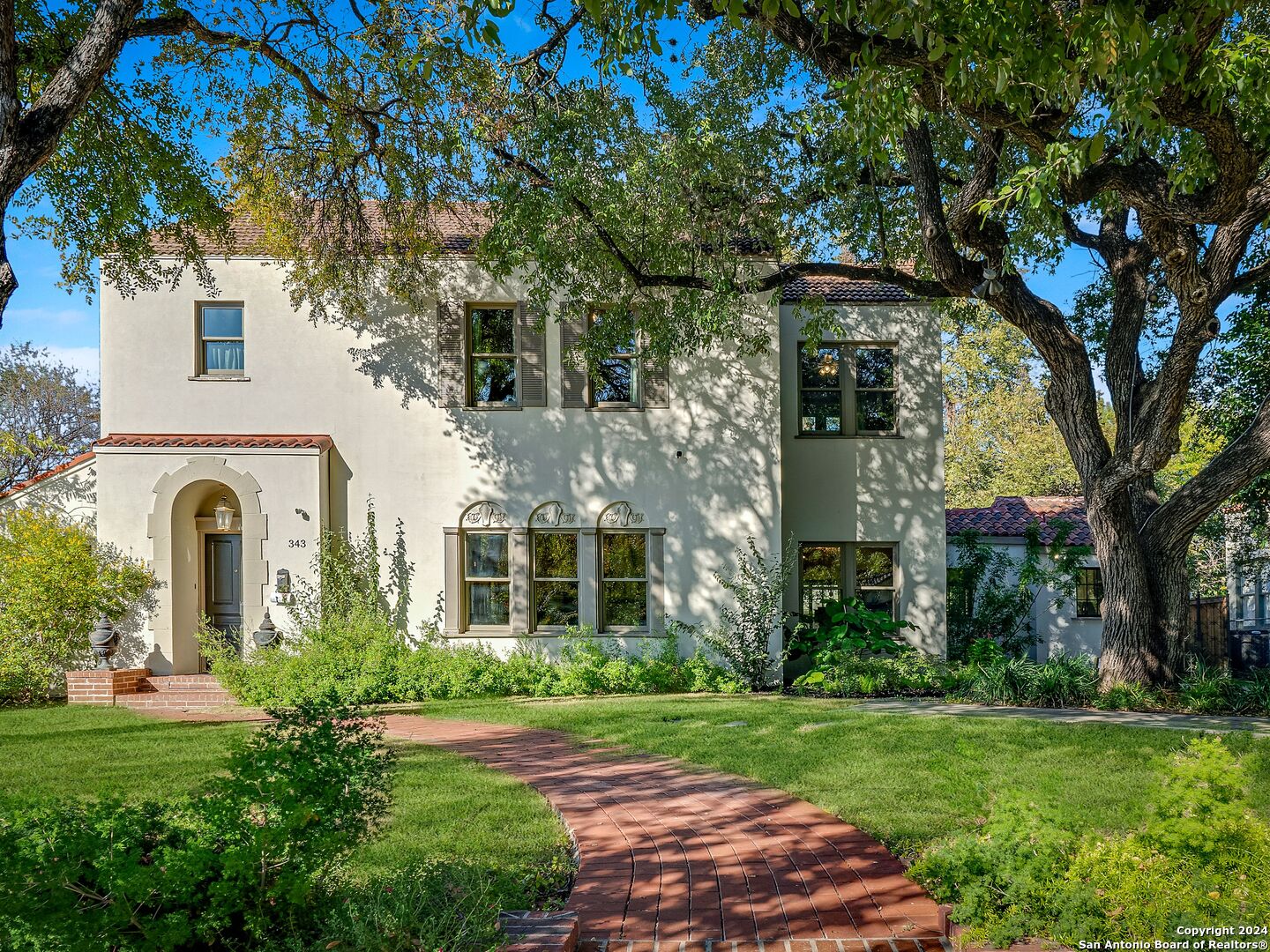 a front view of a house with garden