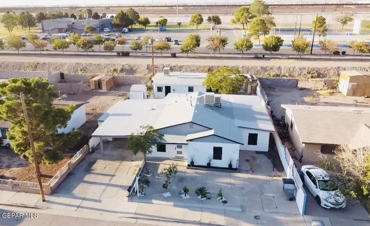 an aerial view of a house with a yard and ocean view