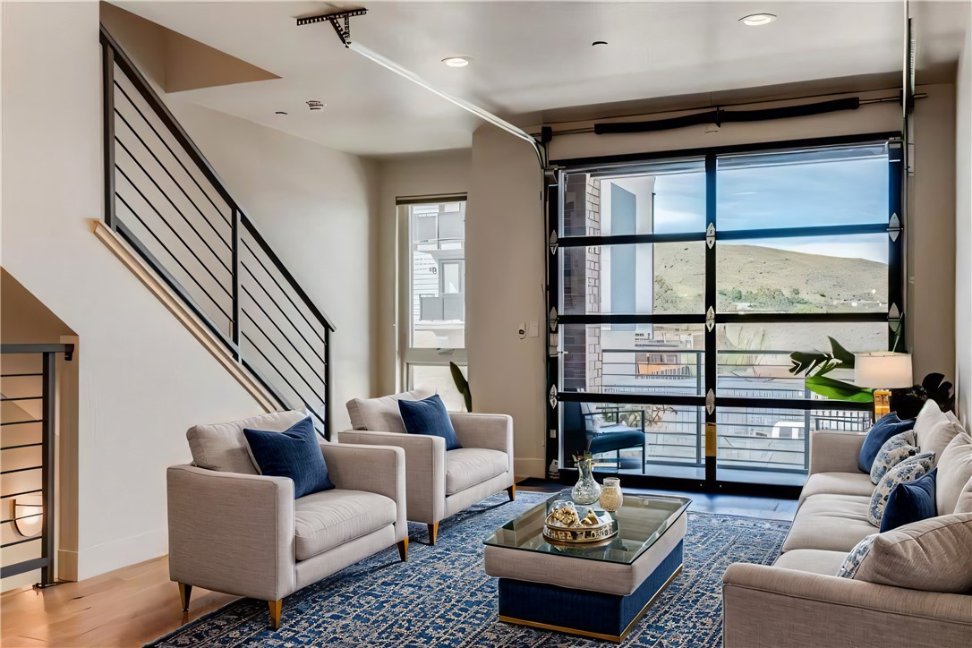 a living room with furniture and a floor to ceiling window