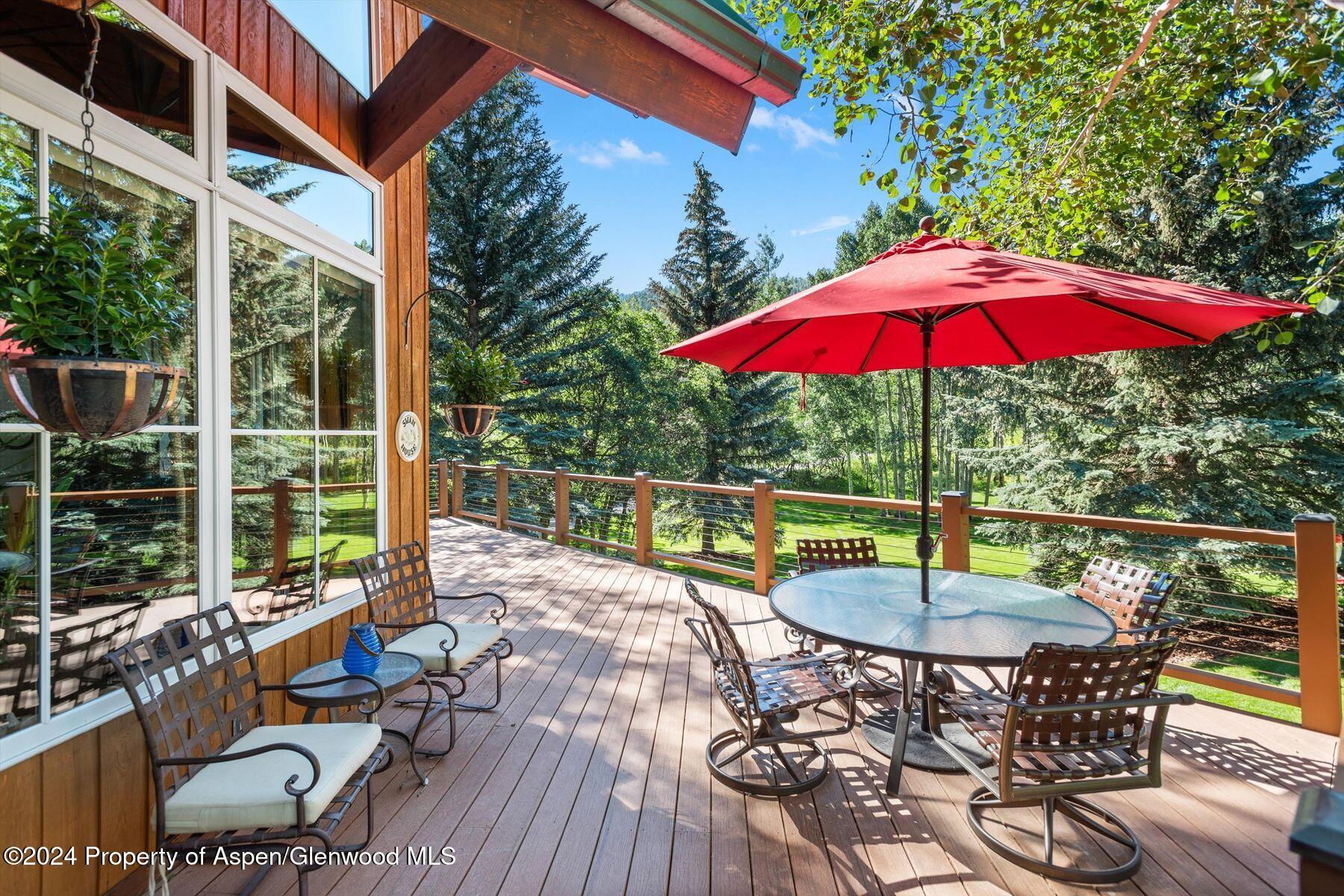 a view of balcony with wooden floor and outdoor seating