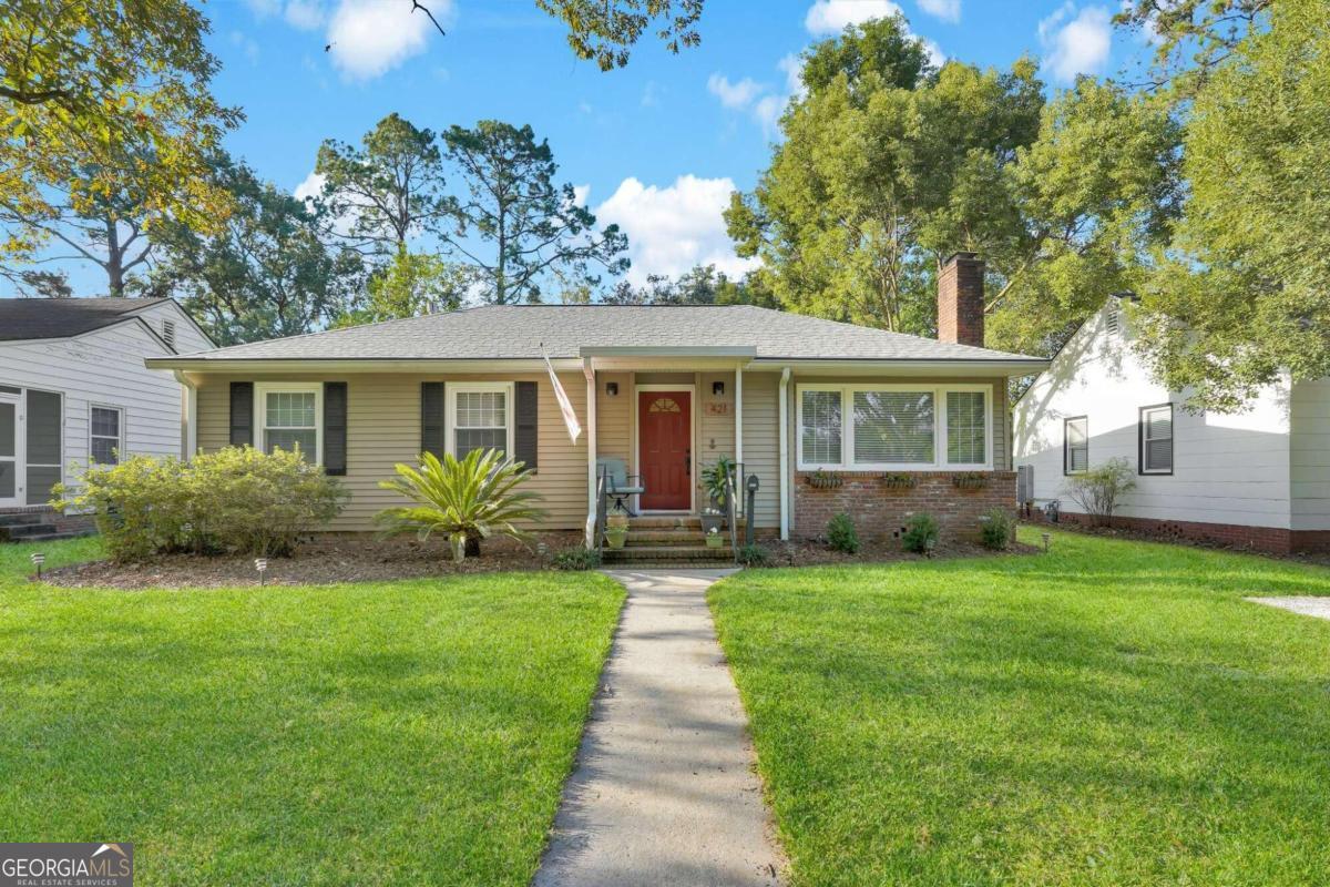 a front view of a house with a garden