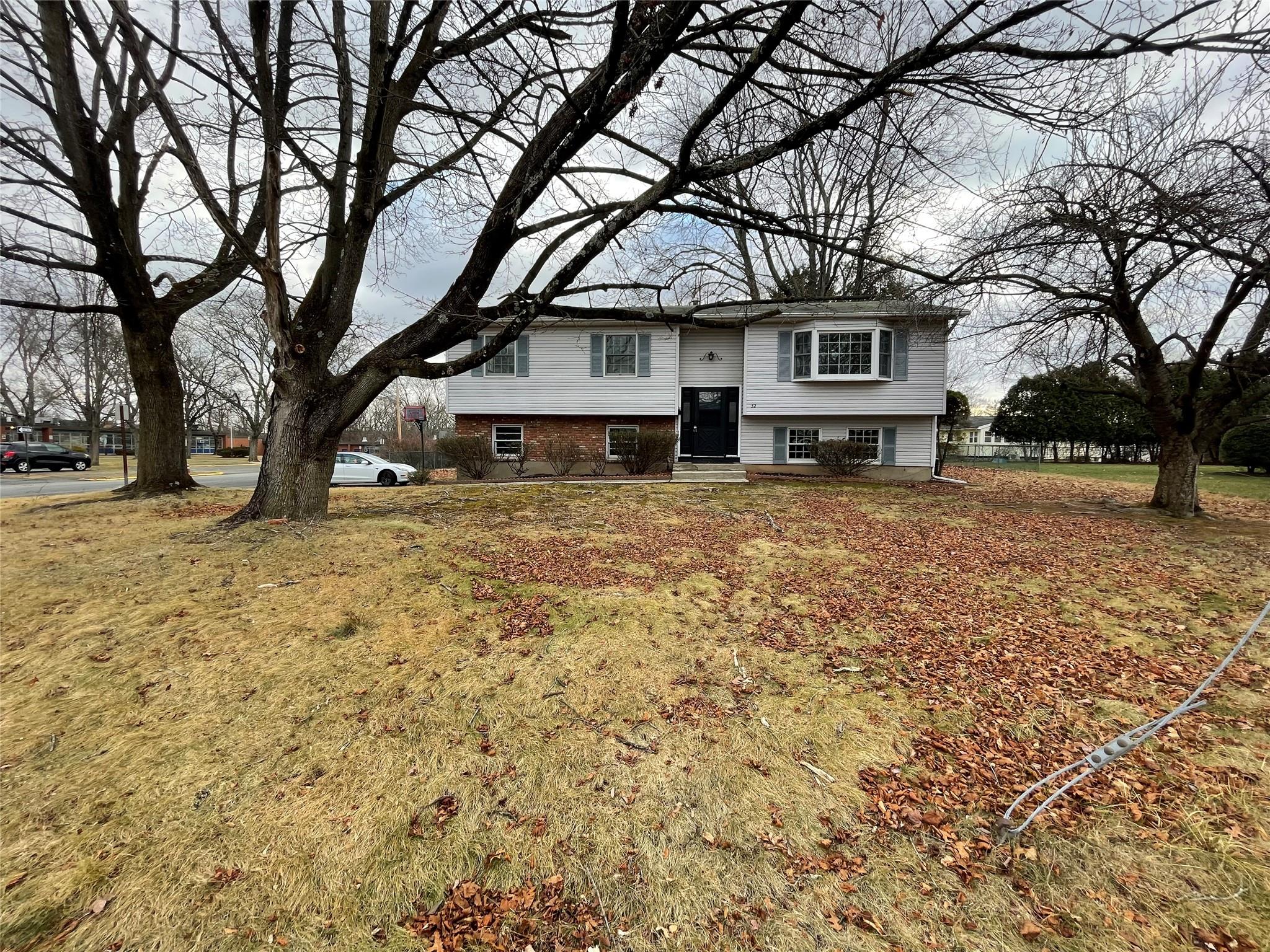 a front view of a house with a yard covered in snow