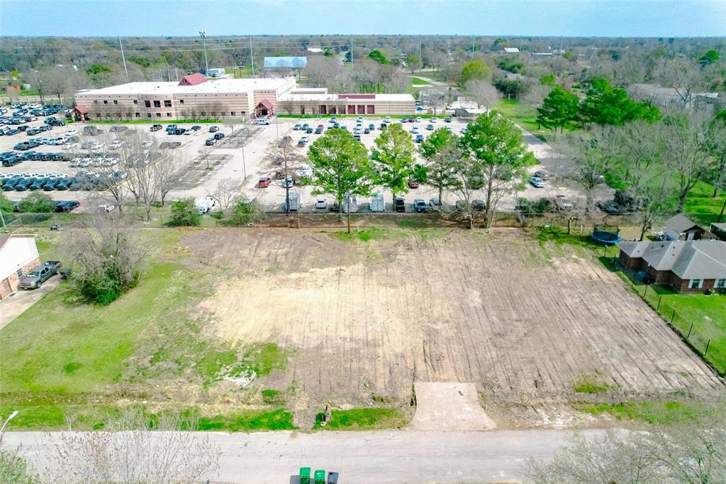 an aerial view of residential houses with outdoor space and river