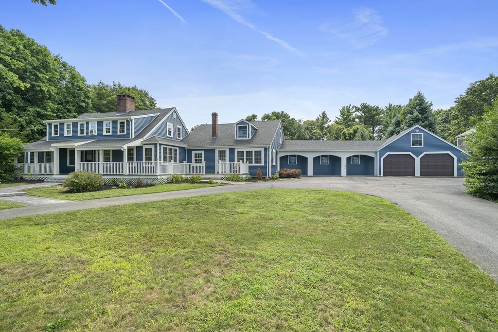 a front view of a house with a garden and yard