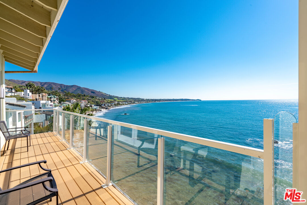 a view of balcony with floor to ceiling window