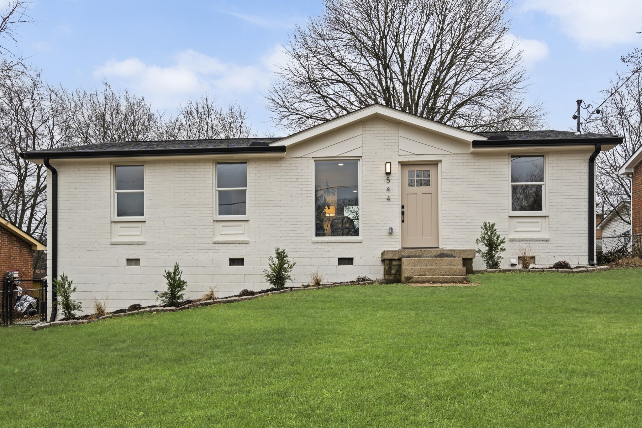 a front view of a house with a yard