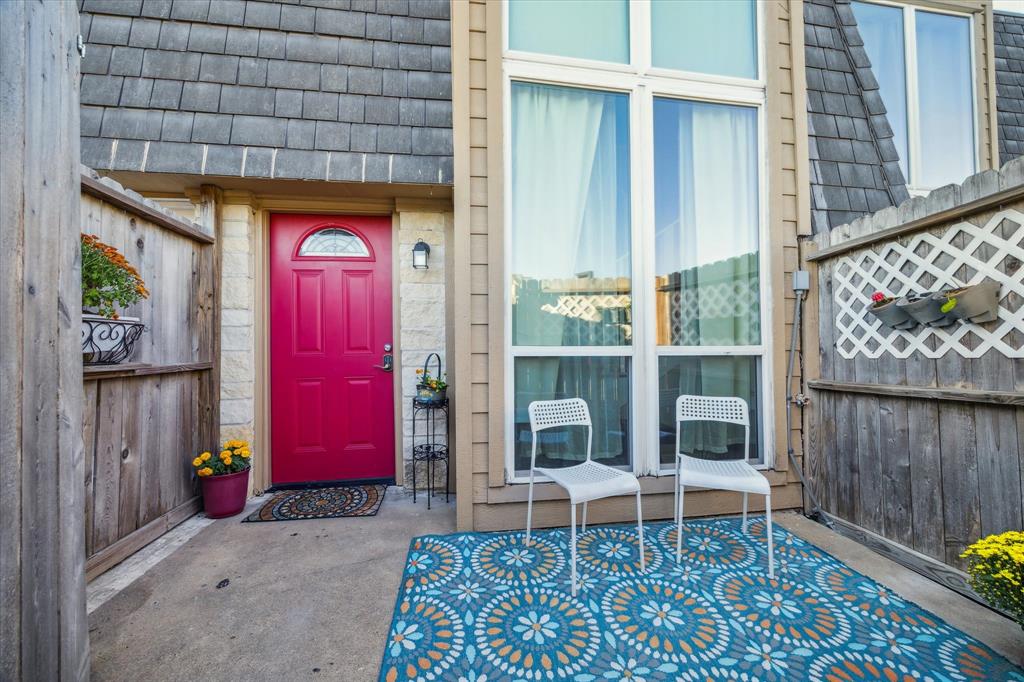 A welcoming entrance with a vibrant red door.energizes the private patio area.