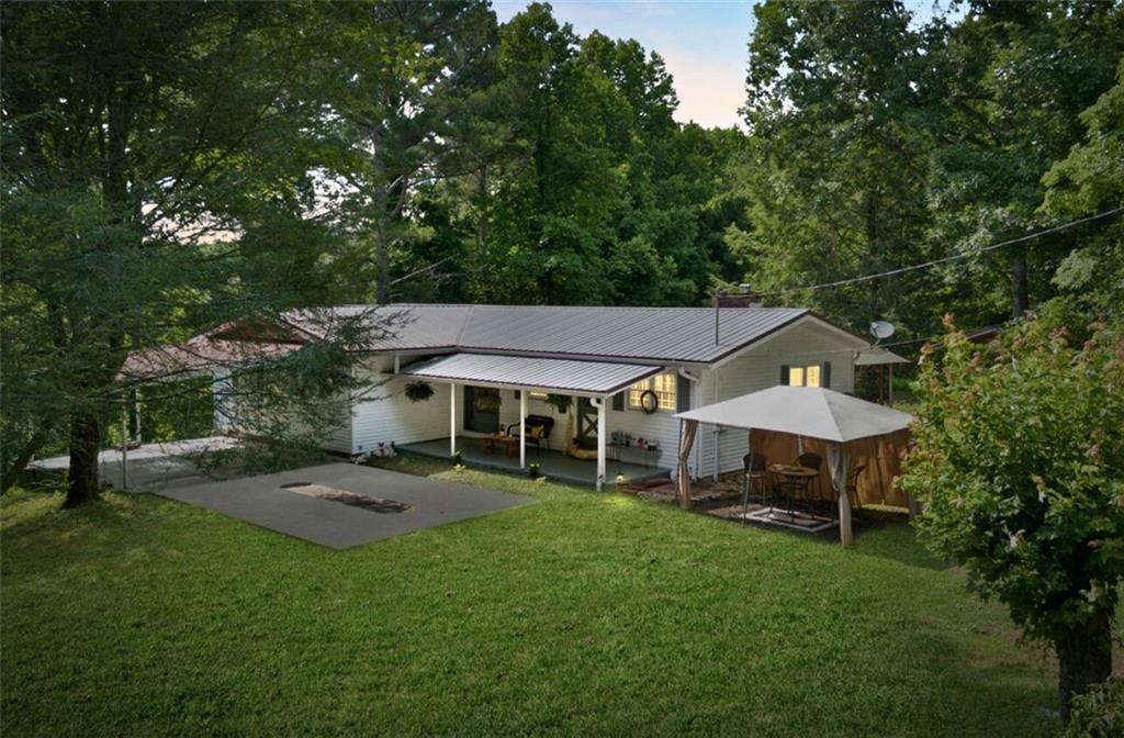 a view of a house with backyard porch and sitting area