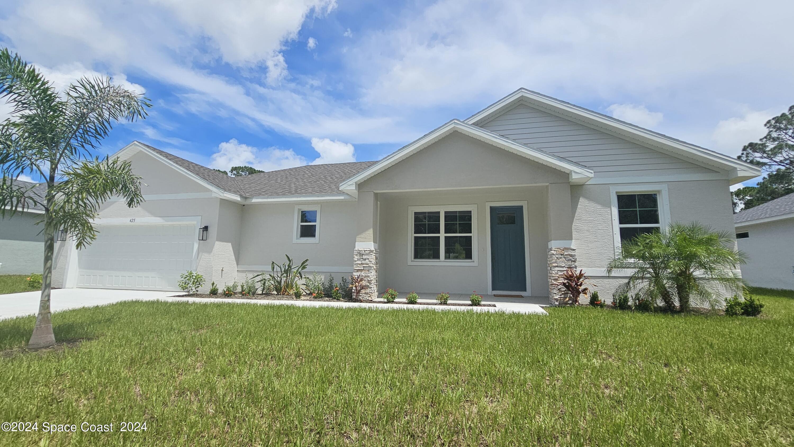 a front view of house with yard and outdoor seating