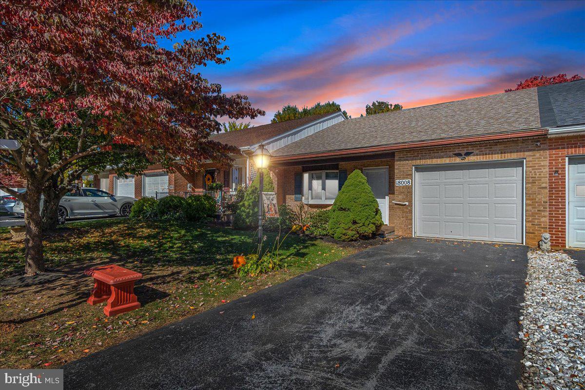 a front view of a house with a yard and outdoor seating