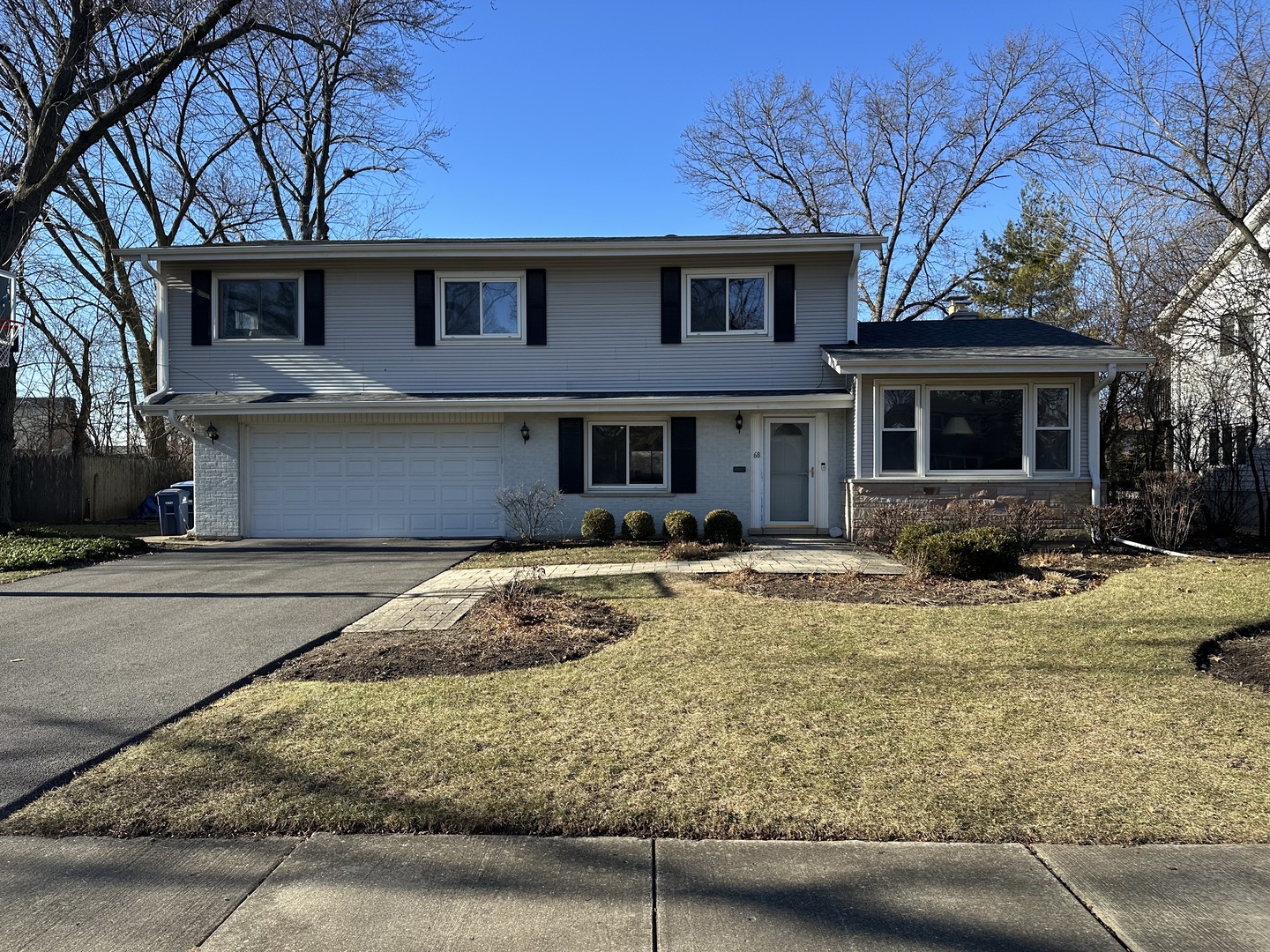 a front view of a house with yard outdoor seating and garage