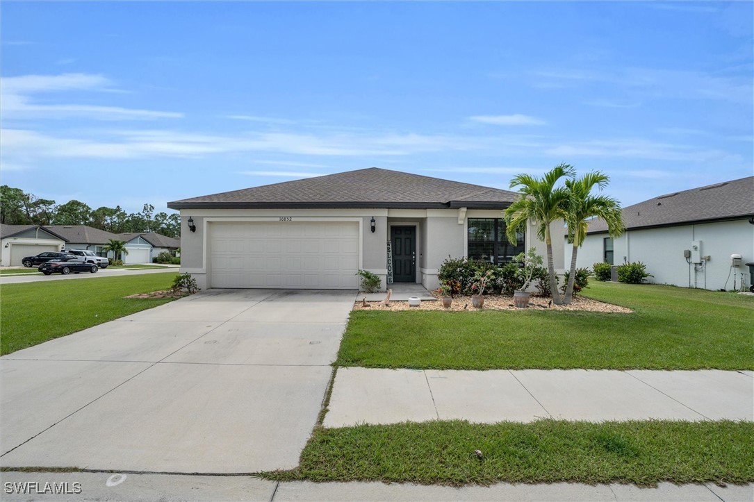 a front view of a house with a yard and garage