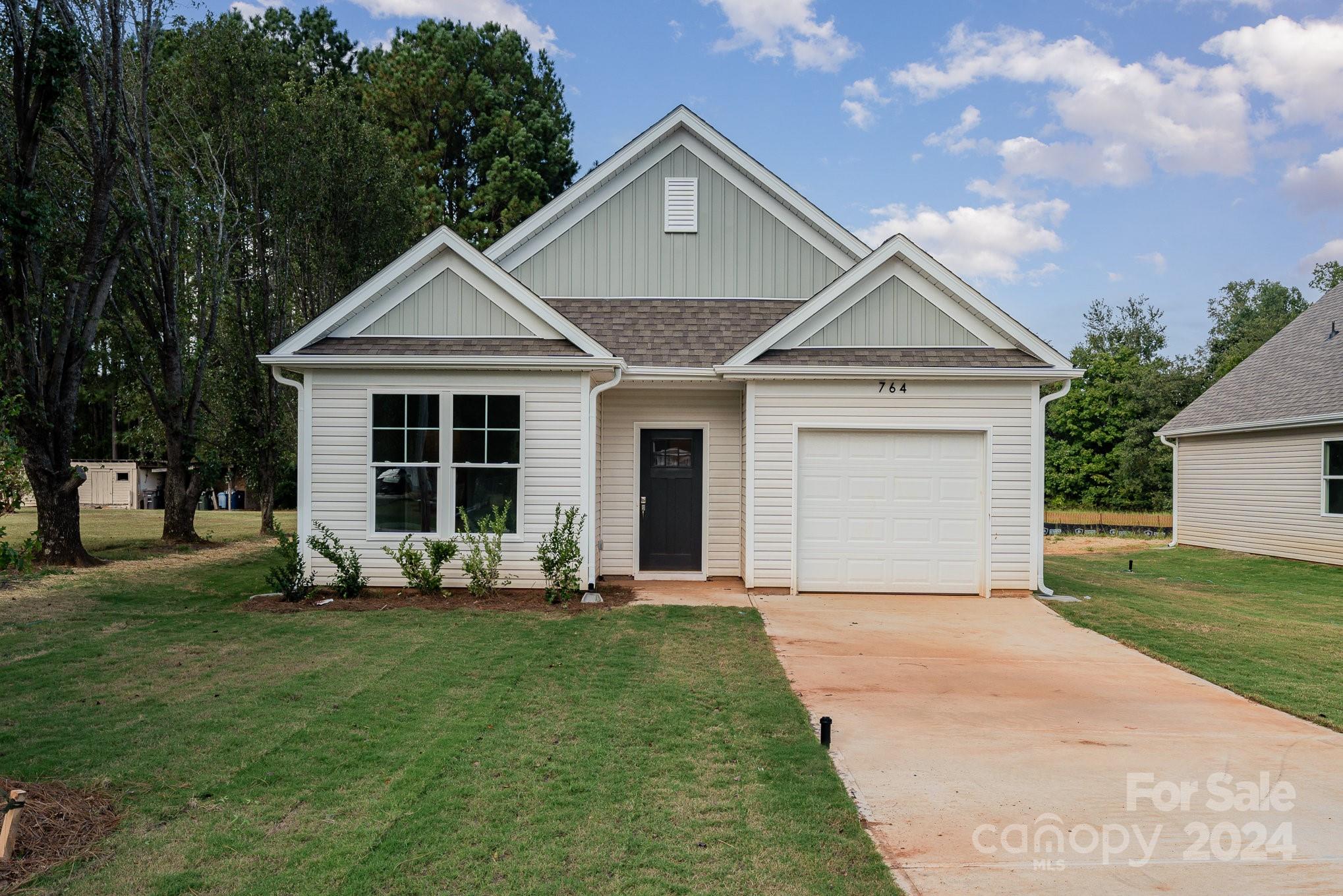 a front view of a house with a yard and porch