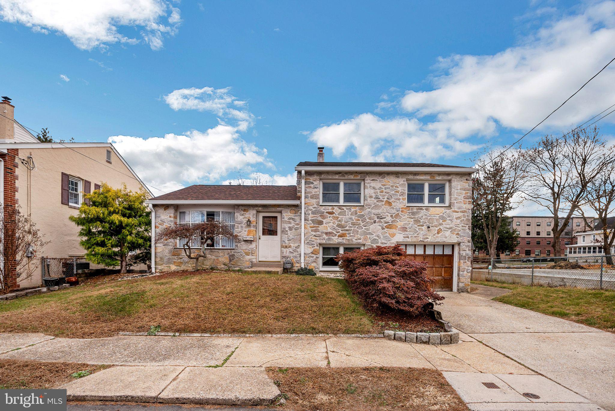 a view of house with yard and sitting area