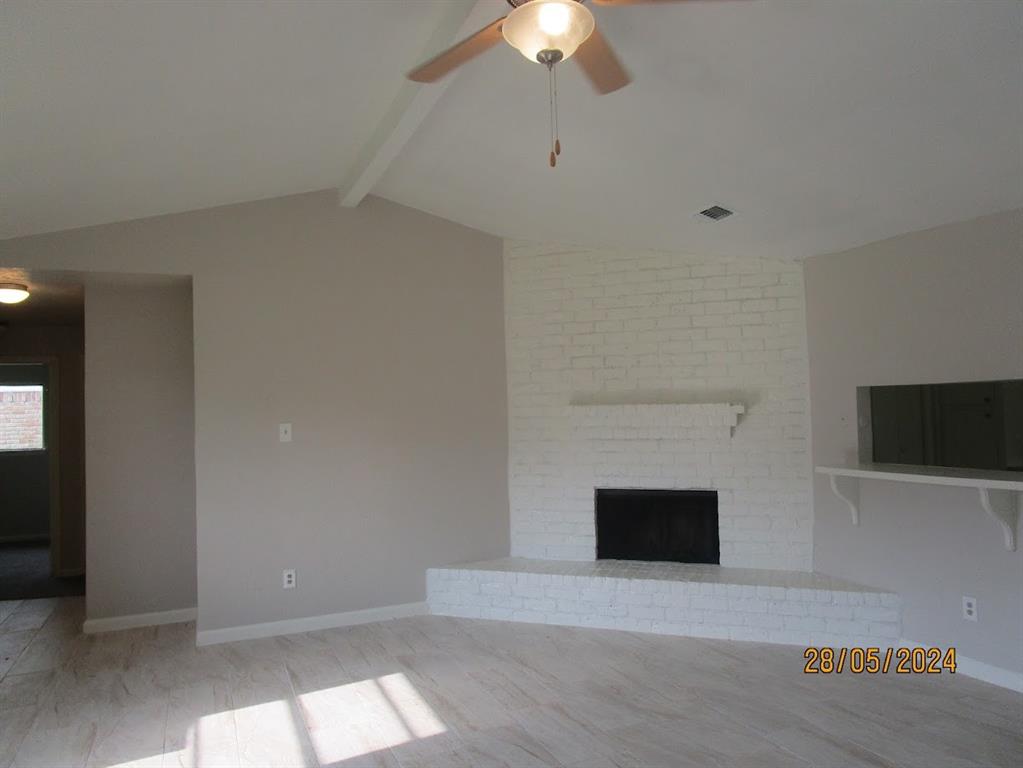 a view of empty room with a fireplace