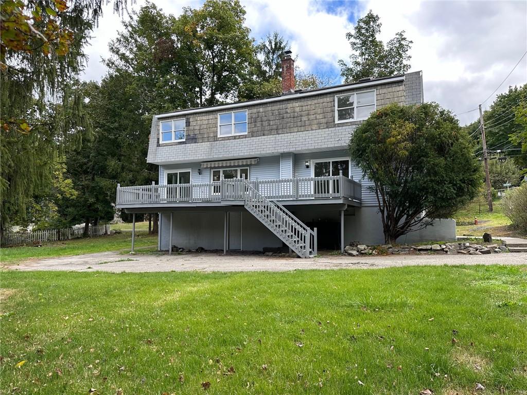 a view of a house with a yard and sitting area