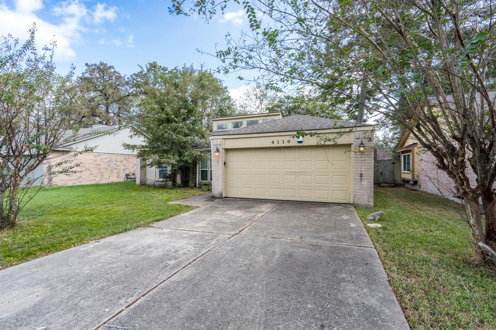 a view of a house with a yard and garage