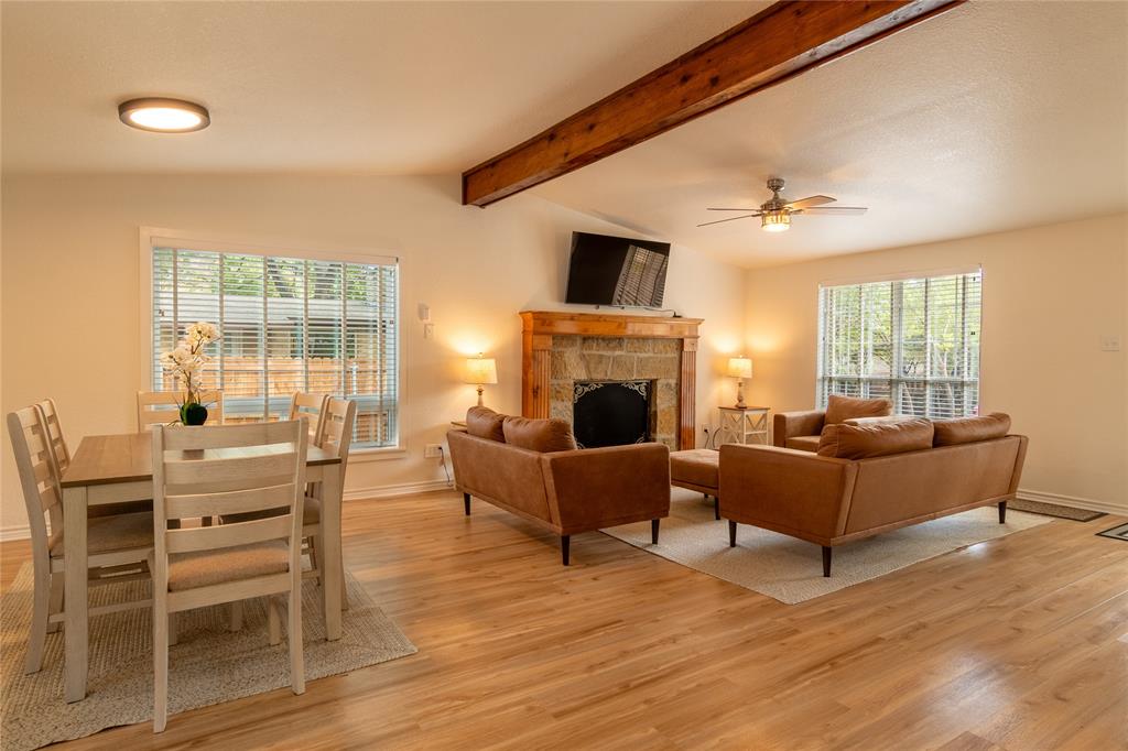 a living room with furniture a flat screen tv and a fireplace