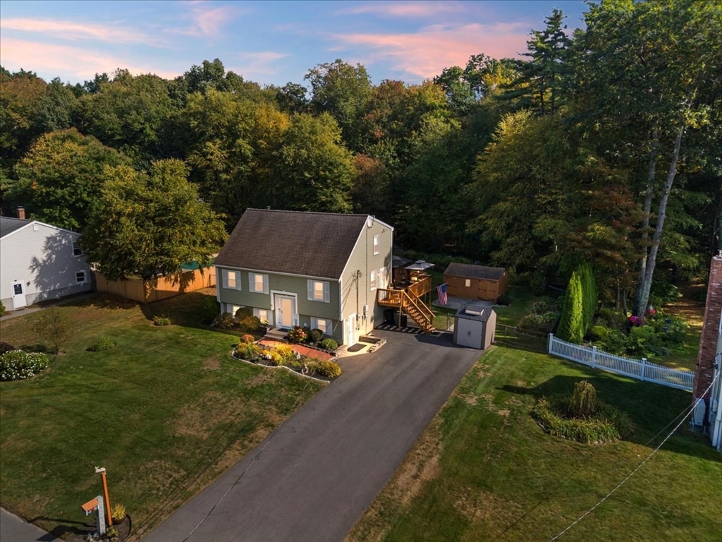 an aerial view of a house with yard swimming pool and outdoor seating