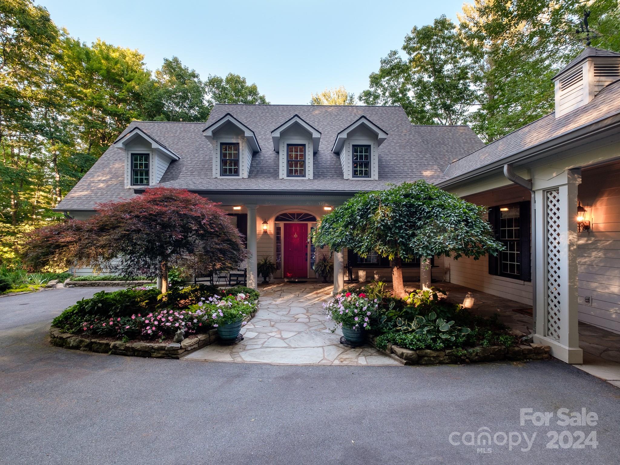 a front view of a house with a garden