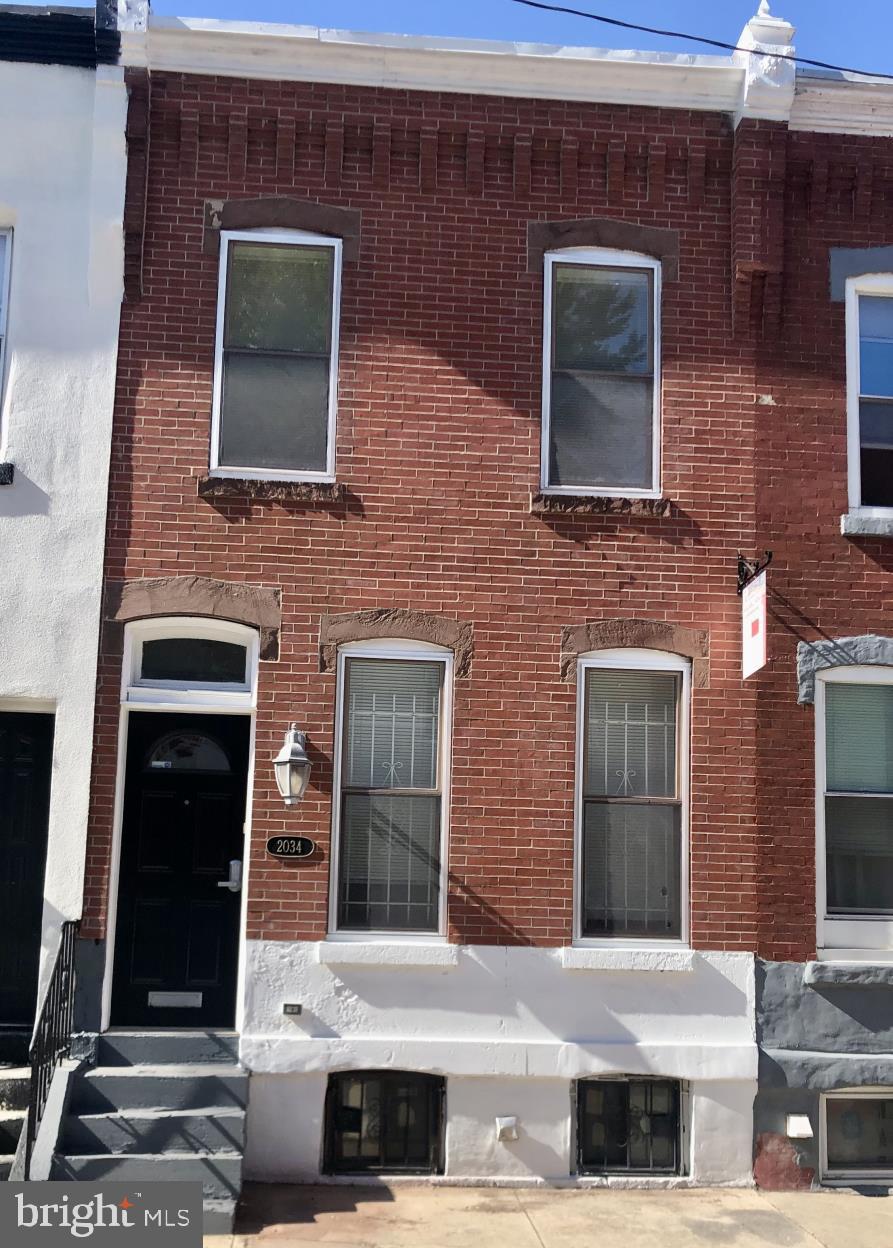 a front view of a house with stairs